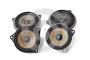 Four speakers of an acoustic system - an audio for playing music in a car interior on a white isolated background in a photo
