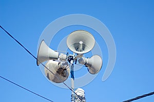 four speakers on the top of a pole