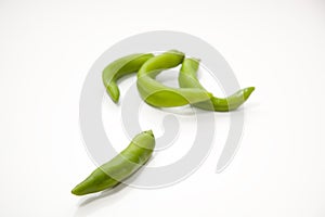 Four spicy green peppers on isolated white