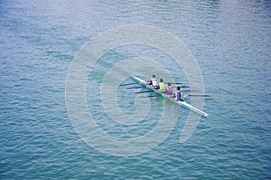 Four sportsmen canoeing, blue river