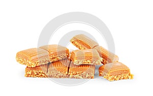 Four square pieces toffee caramel close-up isolated on white background