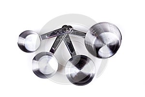 Four stainless steel measuring cups clipped together
