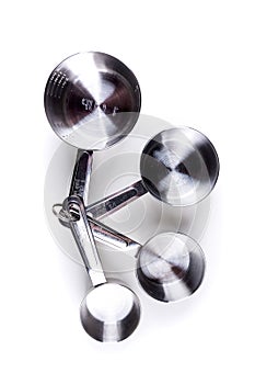 Four stainless steel measuring cups clipped together