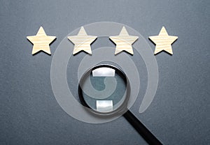 Four stars and a magnifying glass. Rating of hotels and restaurants, expensive institutions. Fame and uniqueness, attracting