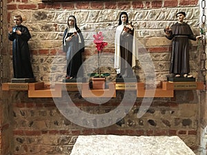 Four statues of saints in a church in Verona, Italy.