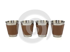 Four steel cups with leather trim in a row, isolated on white background. Camping utensils