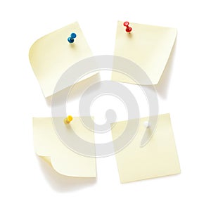 Four sticky notes with push pins