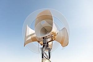 Four street loudspeakers in one bundle on the mast are directed in different directions
