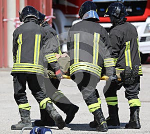 four stretcher bearers carring an injured person