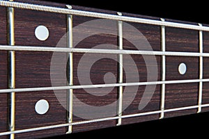 Four string bass guitar fretboard neck with selective focus