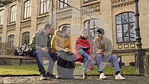 Four students sits at the bench in park