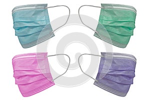 Four surgical masks of different colours, with rubber ear straps. Typical 3-ply surgical mask to cover the mouth and nose.