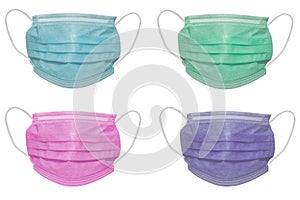 Four surgical masks of different colours, with rubber ear straps. Typical 3-ply surgical mask to cover the mouth and nose.