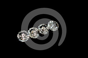 Four swarovski beads. Diamond, crystal beads. Shining. Copy space. Black background. Horizontal image