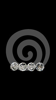 Four swarovski beads. Diamond, crystal beads. Shining. Copy space. Black background. Vertical image