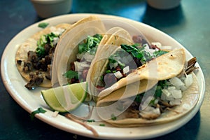 Four tacos on a plate