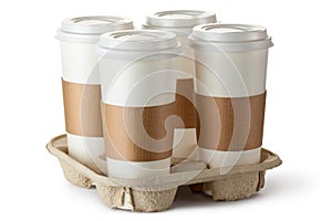Four take-out coffee in holder