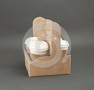 Four take-out coffee in holder