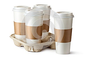 Four take-out coffee. Three cups in holder.