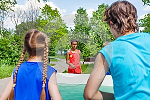 Four teenage friends playing ping pong outside