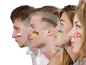 Four teenagers with flags drawn on the faces