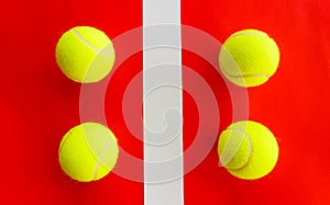 Four tennis balls divided by a field line