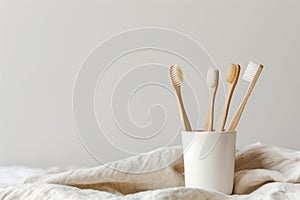 Four Toothbrushes in a Cup on a Bed