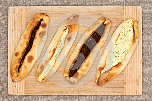 Four traditional Turkish pide with meat and cheese photo