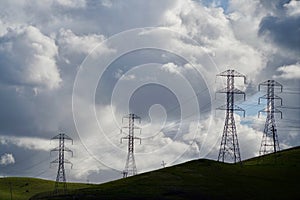 Four Transmission Towers Against Dramatic Clouds