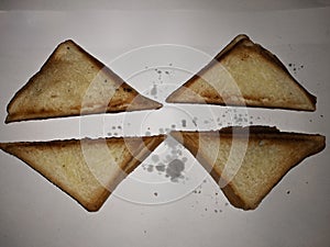 Four warm half-burnt toast on a white background.