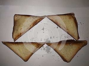 Four warm half-burnt toast on a white background.