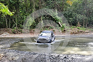 Four-wheel-drive crossing through the shallow water on the Piro River