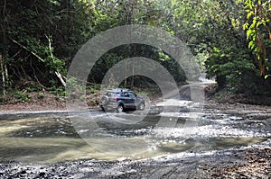 Four-wheel-drive crossing through the shallow water on the Piro River