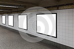 Four white blank billboards in the tunnel.