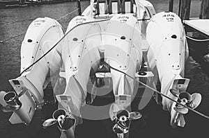 Four white, 425hp outboard motors, tilted out of the water