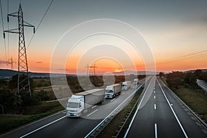 Four White Lorry Trucks Convoy on highway