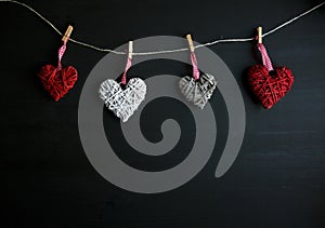 Four white and red hearts on black wooden table. Valentines, spring background. Mock up with copyspace. happy mothers day