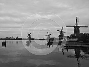 Four windmills on the river Zaan. Black and white. Zaanse Schans, the Netherlands