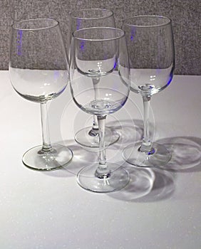 Four wine Glasses On Grey Background