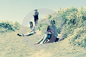 Four women in dunes on Muriwai Beach