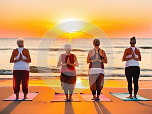 Four women practice yoga on the beach