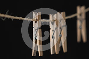 Four wooden clothespins on a wire
