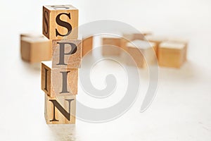 Four wooden cubes arranged in stack with word SPIN meaning Solution Problem Implication Need on them, space for text / image at