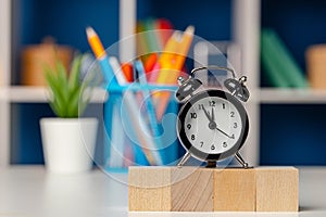 Four wooden cubes with copy space and alarm clock