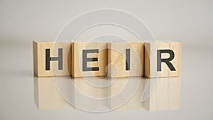 Four wooden cubes with letters Heir. Business marketing concept