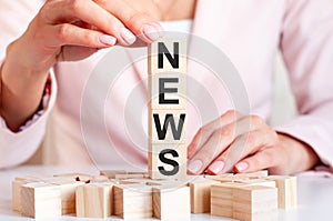 Four wooden cubes with letters news, concept