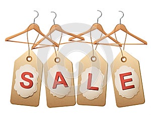 Four wooden hangers with price tags forming the word Sale.