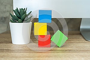 Four wooden toy cubes blocks on wooden table background with copy space