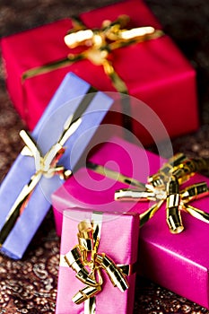 Four Wrapped Gifts with Golden Bows