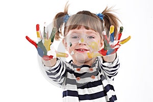 Four-year girl with hands soiled in a paint.